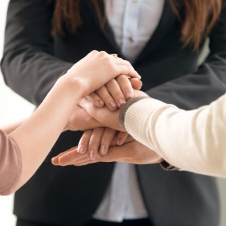 Team management concept, business people joining hands, vertical Successful team management, motivated business people forming spirit to unite, employees putting hands together to motivate group network, launching common project startup, mutual goal and teamwork