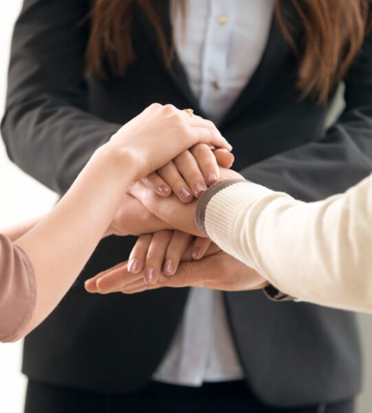 Team management concept, business people joining hands, vertical Successful team management, motivated business people forming spirit to unite, employees putting hands together to motivate group network, launching common project startup, mutual goal and teamwork